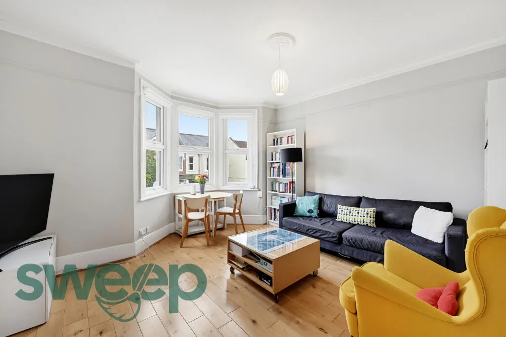A clean living room with a yellow armchair
